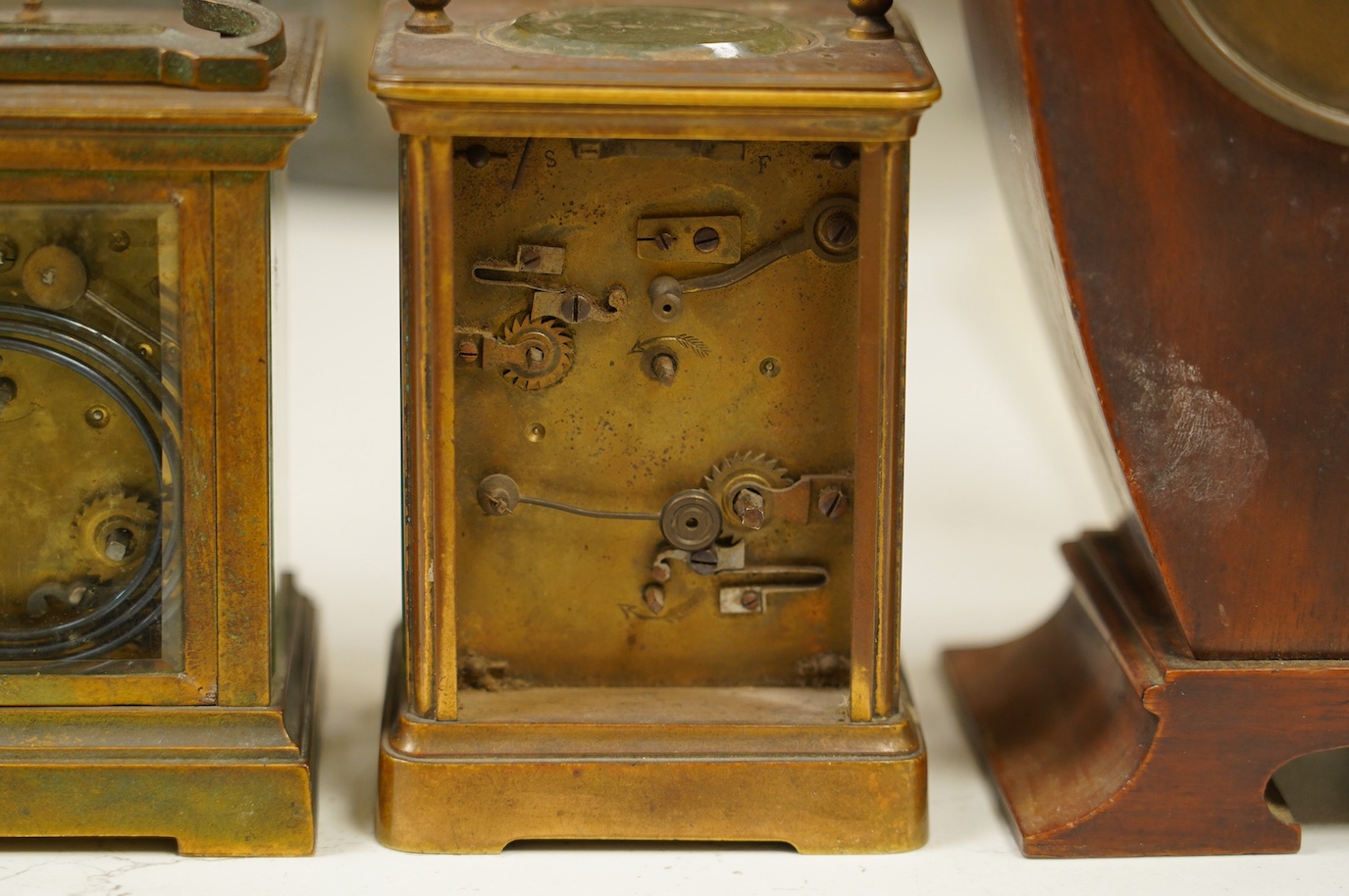 Two carriage clock, an Edwardian mantel clock, 25cm high, and a watch mounted in an oak case (4). Condition - fair, not tested for working